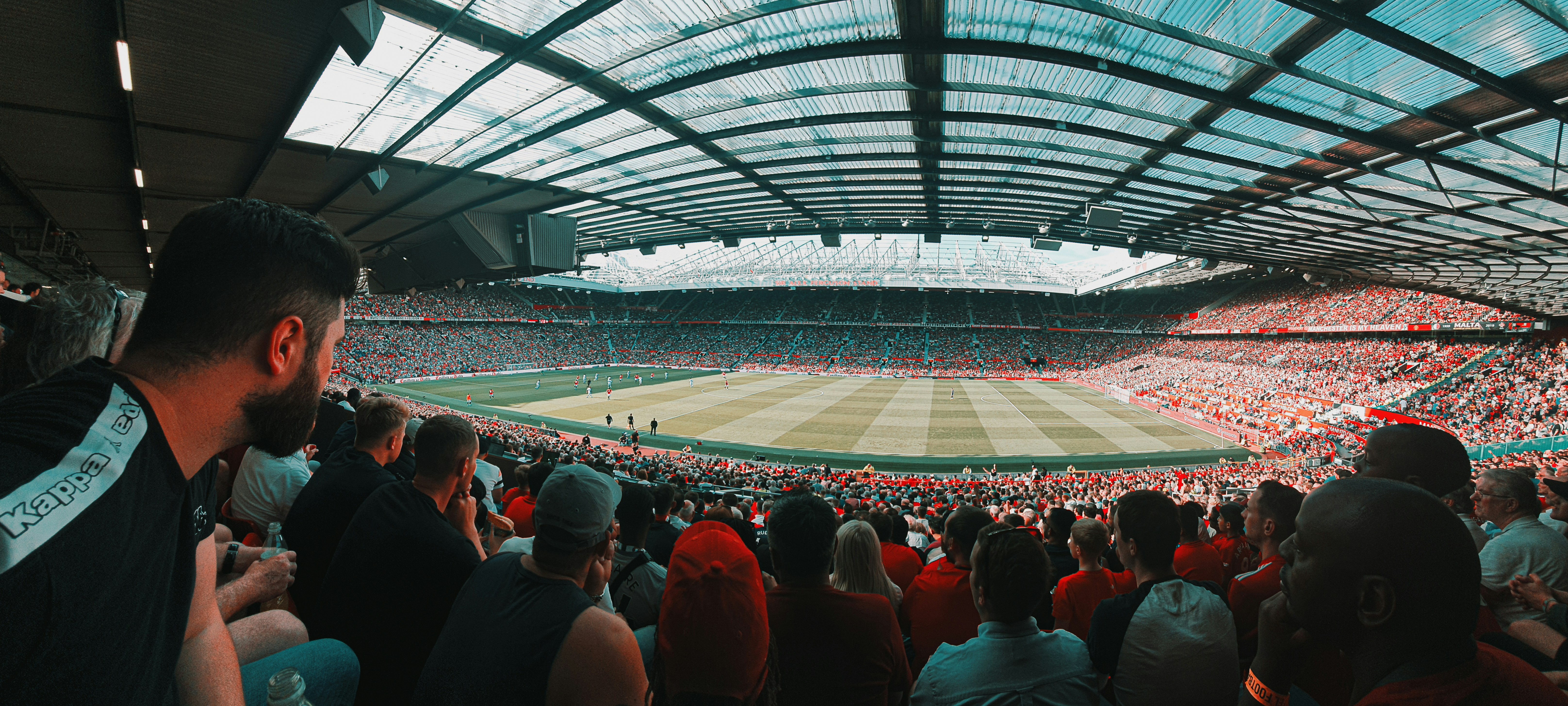 A large crowd of people in a football stadium